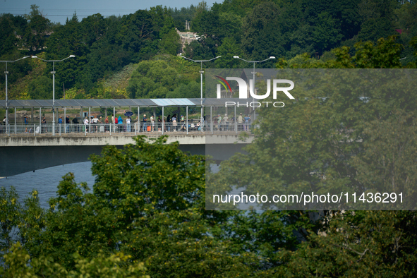 People are seen waiting to cross the border into Russia as seen from  Narva, Estonia on 24 July, 2024. Estonian authorities have closed the...