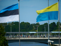 People are seen crossing the border with Russia with Estonia and Ukraine flags flying in Narva, Estonia on 24 July, 2024. Estonian authoriti...