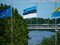 People are seen crossing the border with Russia with EU, Estonia and Ukraine flags flying in Narva, Estonia on 24 July, 2024. Estonian autho...