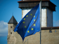 An EU flag is see flying with the Narva Castle in the background in Narva, Estonia on 24 July, 2024. Estonian authorities have closed the br...