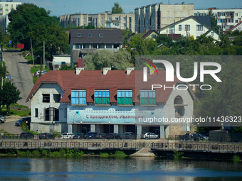 A building with a banner reading ''Happy holidays, Ivangorod'' is seen in Ivangorod, Russia accross the Narva River in Narva, Estonia on 24...