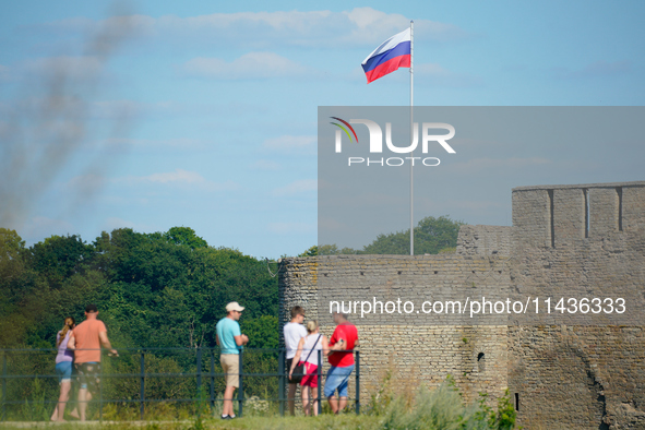 A Russian flag flies on the Ivangorod Frotress as seen from the Narva Castle in Narva, Estonia on 24 July, 2024. Estonian authorities have c...