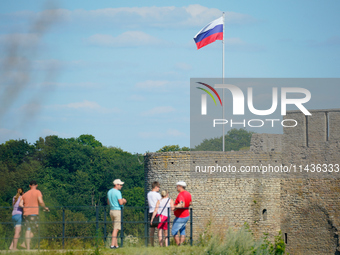 A Russian flag flies on the Ivangorod Frotress as seen from the Narva Castle in Narva, Estonia on 24 July, 2024. Estonian authorities have c...