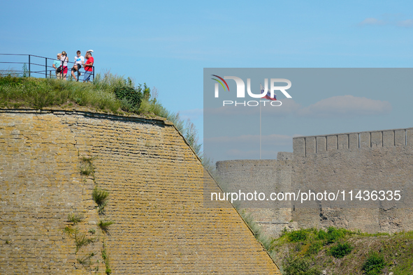 A Russian flag flies on the Ivangorod Frotress as seen from the Narva Castle in Narva, Estonia on 24 July, 2024. Estonian authorities have c...