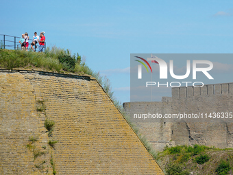 A Russian flag flies on the Ivangorod Frotress as seen from the Narva Castle in Narva, Estonia on 24 July, 2024. Estonian authorities have c...