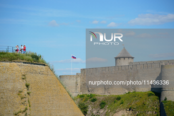 A Russian flag flies on the Ivangorod Frotress as seen from the Narva Castle in Narva, Estonia on 24 July, 2024. Estonian authorities have c...