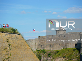 A Russian flag flies on the Ivangorod Frotress as seen from the Narva Castle in Narva, Estonia on 24 July, 2024. Estonian authorities have c...