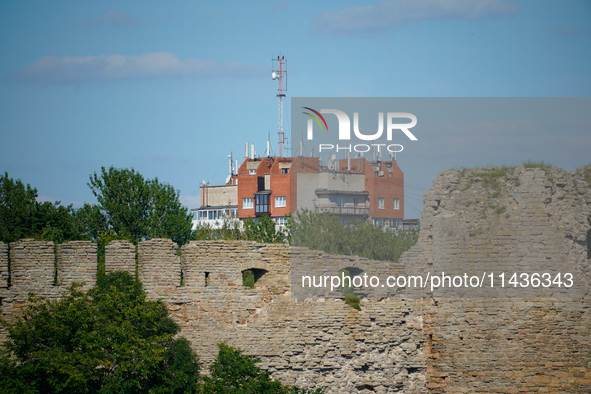 A building with antennas is seen beyond a wall of the Ivangorod Fortress in Ivangorod, Russia on 24 July, 2024. Estonian authorities have cl...