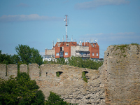 A building with antennas is seen beyond a wall of the Ivangorod Fortress in Ivangorod, Russia on 24 July, 2024. Estonian authorities have cl...