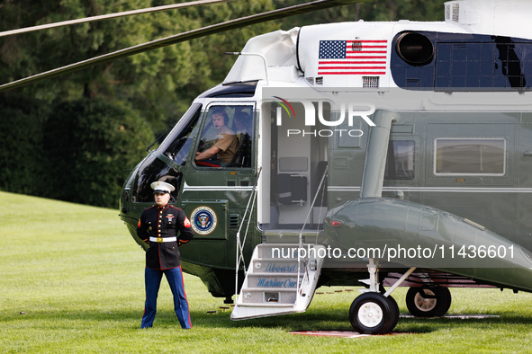 U.S. Marines wait for President Joe Biden to depart the White House to board Marine One en route to Camp David on July 26, 2024. 