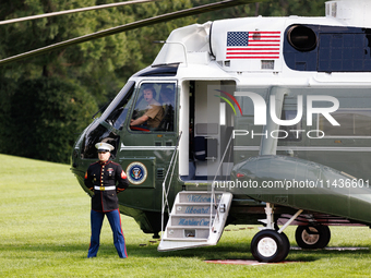 U.S. Marines wait for President Joe Biden to depart the White House to board Marine One en route to Camp David on July 26, 2024. (