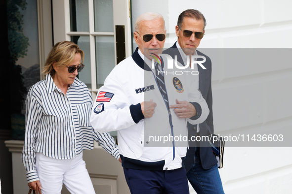 U.S. President Joe Biden, wearing a Team USA 2024 Olympics jacket, departs the White House, accompanied by his sister Valerie Biden Owens an...