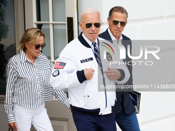 U.S. President Joe Biden, wearing a Team USA 2024 Olympics jacket, departs the White House, accompanied by his sister Valerie Biden Owens an...