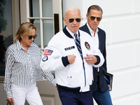 U.S. President Joe Biden, wearing a Team USA 2024 Olympics jacket, departs the White House, accompanied by his sister Valerie Biden Owens an...