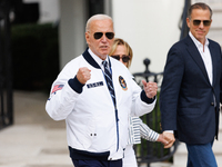 U.S. President Joe Biden, wearing a Team USA 2024 Olympics jacket, departs the White House, accompanied by his sister Valerie Biden Owens an...