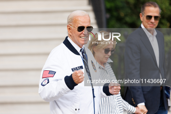 U.S. President Joe Biden, wearing a Team USA 2024 Olympics jacket, departs the White House, accompanied by his sister Valerie Biden Owens an...