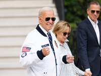 U.S. President Joe Biden, wearing a Team USA 2024 Olympics jacket, departs the White House, accompanied by his sister Valerie Biden Owens an...