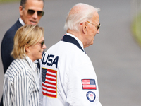 U.S. President Joe Biden, wearing a Team USA 2024 Olympics jacket, departs the White House, accompanied by his sister Valerie Biden Owens an...