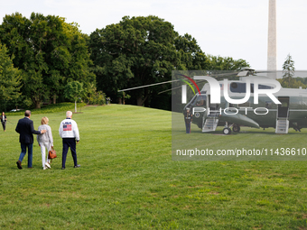 U.S. President Joe Biden, wearing a Team USA 2024 Olympics jacket, departs the White House, accompanied by his sister Valerie Biden Owens an...