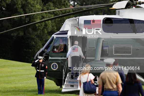 U.S. President Joe Biden, wearing a Team USA 2024 Olympics jacket, boards Marine One en route to Camp David on the South Lawn of the White H...