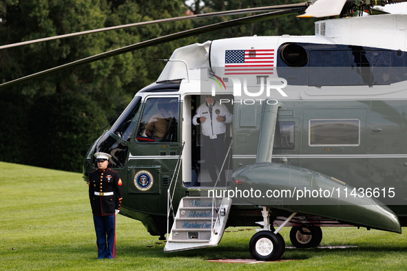 U.S. President Joe Biden turns towards the press and points to his Team USA 2024 Olympics jacket as he boards Marine One en route to Camp Da...