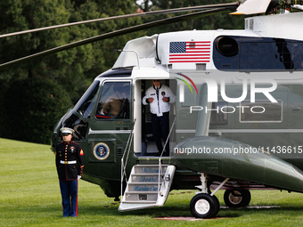 U.S. President Joe Biden turns towards the press and points to his Team USA 2024 Olympics jacket as he boards Marine One en route to Camp Da...