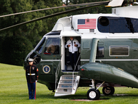 U.S. President Joe Biden turns towards the press and points to his Team USA 2024 Olympics jacket as he boards Marine One en route to Camp Da...