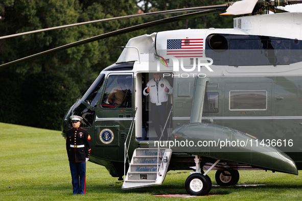 U.S. President Joe Biden turns towards the press and points to his Team USA 2024 Olympics jacket as he boards Marine One en route to Camp Da...