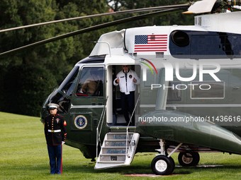 U.S. President Joe Biden turns towards the press and points to his Team USA 2024 Olympics jacket as he boards Marine One en route to Camp Da...