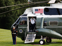 U.S. President Joe Biden turns towards the press and points to his Team USA 2024 Olympics jacket as he boards Marine One en route to Camp Da...