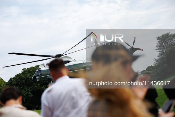 People watch as U.S. President Joe Biden departs the White House aboard Marine One en route to Camp David on July 26, 2024. 