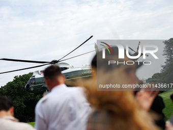 People watch as U.S. President Joe Biden departs the White House aboard Marine One en route to Camp David on July 26, 2024. (