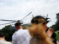 People watch as U.S. President Joe Biden departs the White House aboard Marine One en route to Camp David on July 26, 2024. (