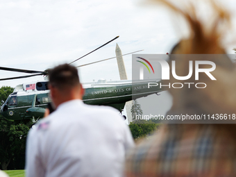 People watch as U.S. President Joe Biden departs the White House aboard Marine One en route to Camp David on July 26, 2024. (