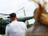 People watch as U.S. President Joe Biden departs the White House aboard Marine One en route to Camp David on July 26, 2024. (