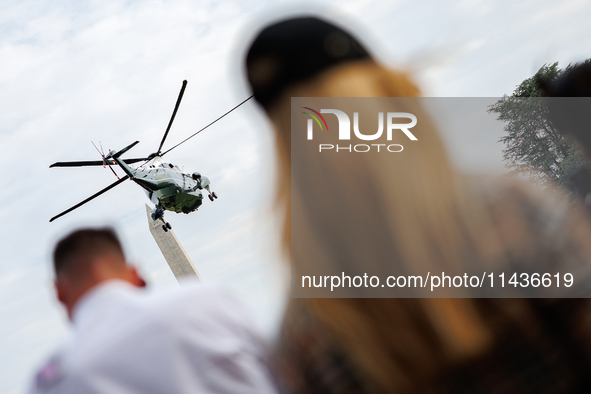 People watch as U.S. President Joe Biden departs the White House aboard Marine One en route to Camp David on July 26, 2024. 