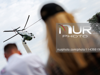 People watch as U.S. President Joe Biden departs the White House aboard Marine One en route to Camp David on July 26, 2024. (