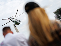 People watch as U.S. President Joe Biden departs the White House aboard Marine One en route to Camp David on July 26, 2024. (