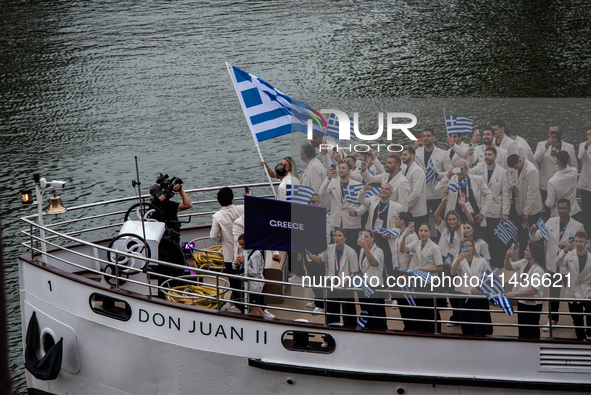 The boat of the Hellenic Olympic team is passing in front of the public along the Seine during the opening ceremony of the Paris Olympic Gam...