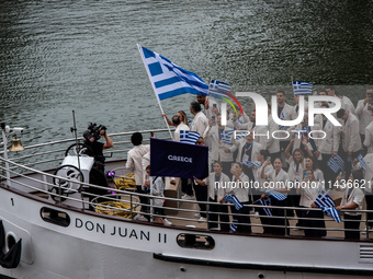 The boat of the Hellenic Olympic team is passing in front of the public along the Seine during the opening ceremony of the Paris Olympic Gam...