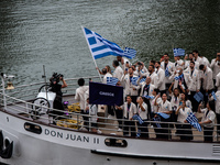 The boat of the Hellenic Olympic team is passing in front of the public along the Seine during the opening ceremony of the Paris Olympic Gam...