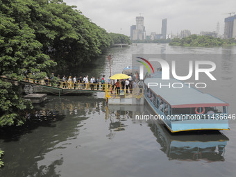 People are waiting in queue to board the water bus as government and non-government offices are opening today after 4 days of curfew followi...