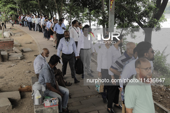 People are waiting in queue to board the water bus as government and non-government offices are opening today after 4 days of curfew followi...