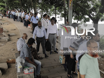 People are waiting in queue to board the water bus as government and non-government offices are opening today after 4 days of curfew followi...