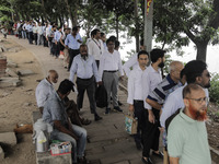 People are waiting in queue to board the water bus as government and non-government offices are opening today after 4 days of curfew followi...