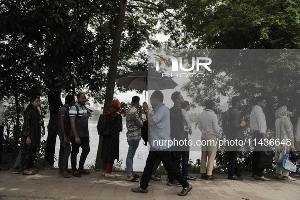 People are waiting in queue to board the water bus as government and non-government offices are opening today after 4 days of curfew followi...