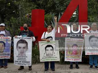 Mothers, fathers, and relatives of students from the Isidro Burgos Normal School in Ayotzinapa are demonstrating in Mexico City, Mexico, to...