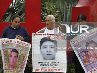 Mothers, fathers, and relatives of students from the Isidro Burgos Normal School in Ayotzinapa are demonstrating in Mexico City, Mexico, to...