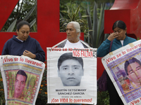 Mothers, fathers, and relatives of students from the Isidro Burgos Normal School in Ayotzinapa are demonstrating in Mexico City, Mexico, to...