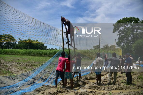 An Indian forest official is setting up a net trap to capture a Royal Bengal tiger near a jute field in Dhing, Nagaon District of Assam, on...